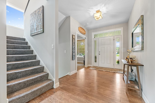 19550 Albany Cir NW, Elk River, MN 55330 - entryway with stairway and light wood-style flooring