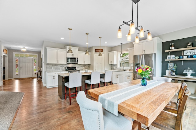 19550 Albany Cir NW, Elk River, MN 55330 - dining room featuring light wood-type flooring and recessed lighting