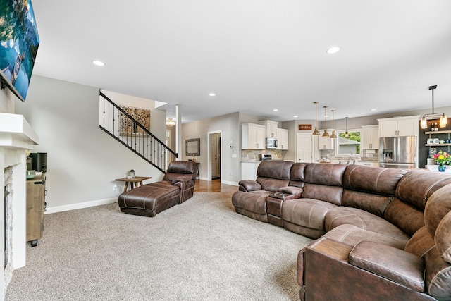 19550 Albany Cir NW, Elk River, MN 55330 - living room featuring light carpet, recessed lighting, and stairs