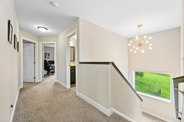 19550 Albany Cir NW, Elk River, MN 55330 - hall with an upstairs landing, a chandelier, and light colored carpet