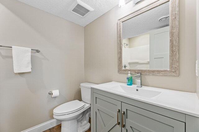 19550 Albany Cir NW, Elk River, MN 55330 - bathroom featuring vanity, wood finished floors, and a textured ceiling