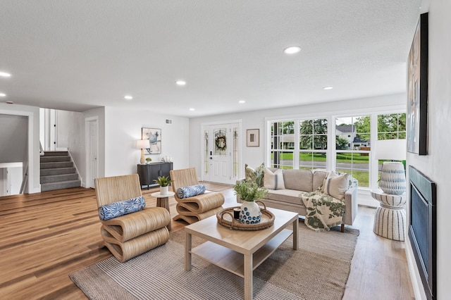 6901 Dawson Ln, Edina, MN 55435 - living room with wood finished floors, stairway, and recessed lighting
