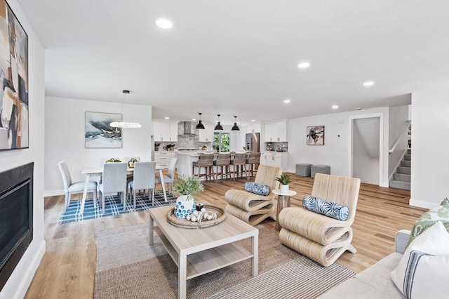 6901 Dawson Ln, Edina, MN 55435 - living area featuring stairway, light wood-style flooring, and recessed lighting
