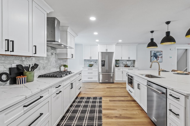 6901 Dawson Ln, Edina, MN 55435 - kitchen with appliances with stainless steel finishes, wall chimney range hood, recessed lighting, white cabinetry, and tasteful backsplash