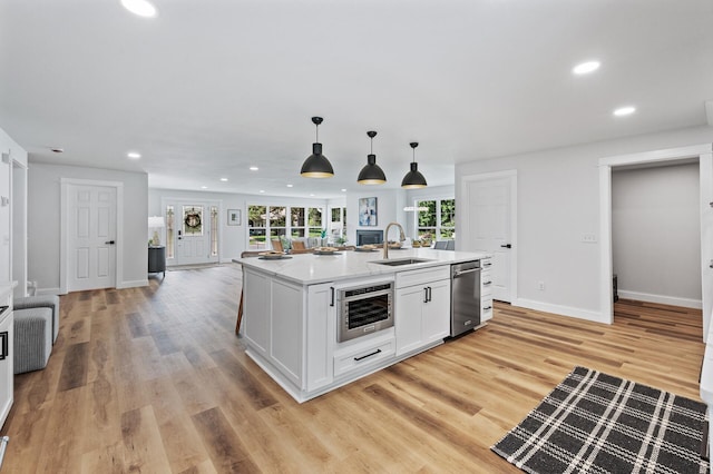 6901 Dawson Ln, Edina, MN 55435 - kitchen with dishwasher, recessed lighting, white cabinetry, light wood-style floors, and decorative light fixtures