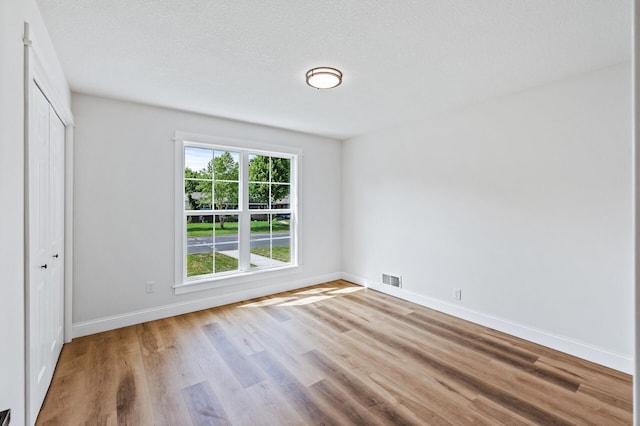 6901 Dawson Ln, Edina, MN 55435 - unfurnished bedroom featuring wood finished floors and a closet