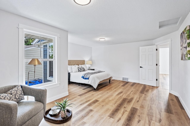6901 Dawson Ln, Edina, MN 55435 - bedroom featuring wood finished floors and attic access