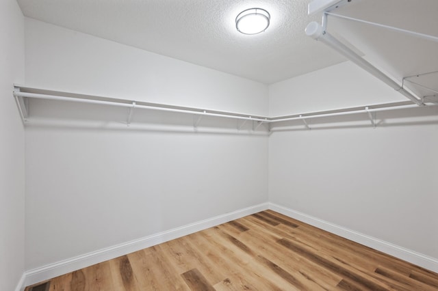 6901 Dawson Ln, Edina, MN 55435 - walk in closet featuring wood finished floors