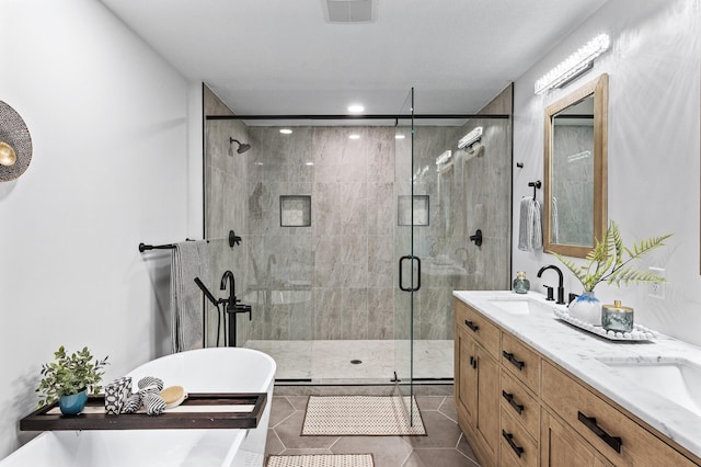 6901 Dawson Ln, Edina, MN 55435 - full bath featuring a soaking tub, a shower stall, double vanity, tile patterned flooring, and recessed lighting
