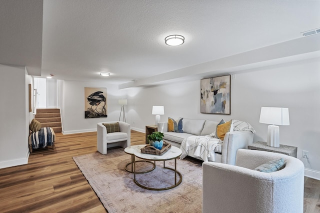 6901 Dawson Ln, Edina, MN 55435 - living area featuring wood finished floors, stairway, and a textured ceiling