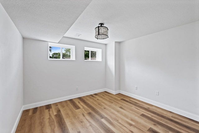 6901 Dawson Ln, Edina, MN 55435 - spare room featuring light wood-type flooring and a textured ceiling