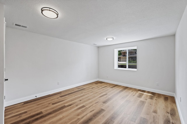 6901 Dawson Ln, Edina, MN 55435 - unfurnished room with a textured ceiling and light wood-style floors