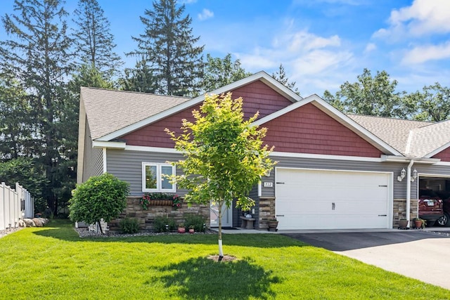 722 Hilltop Dr, Taylors Falls, MN 55084 - craftsman inspired home with stone siding, asphalt driveway, roof with shingles, an attached garage, and a front yard