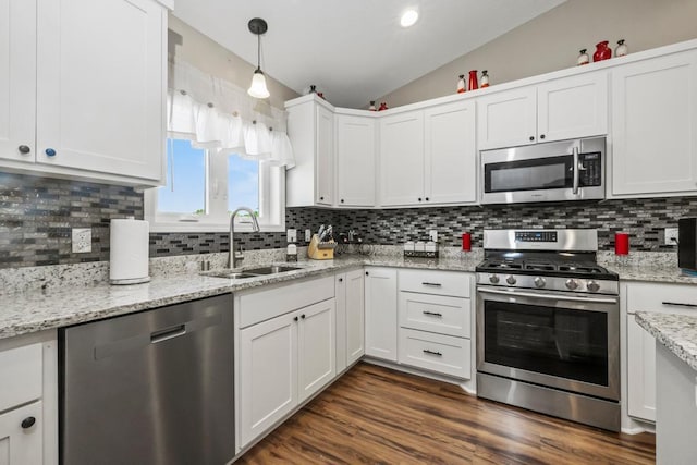 722 Hilltop Dr, Taylors Falls, MN 55084 - kitchen featuring stainless steel appliances, lofted ceiling, white cabinetry, backsplash, and light stone countertops