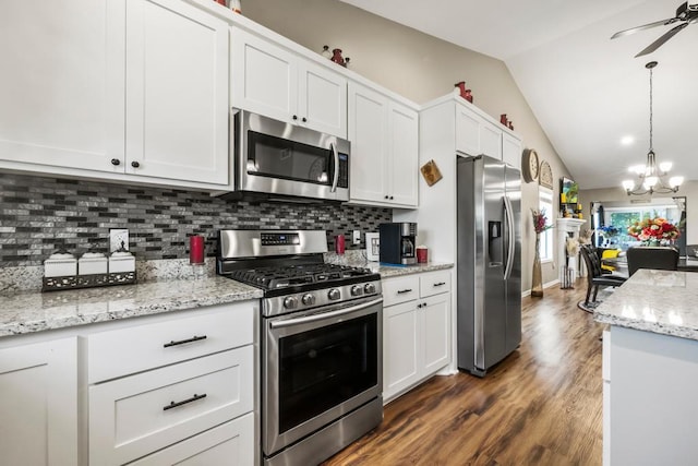 722 Hilltop Dr, Taylors Falls, MN 55084 - kitchen featuring appliances with stainless steel finishes, a chandelier, vaulted ceiling, tasteful backsplash, and dark wood-style floors