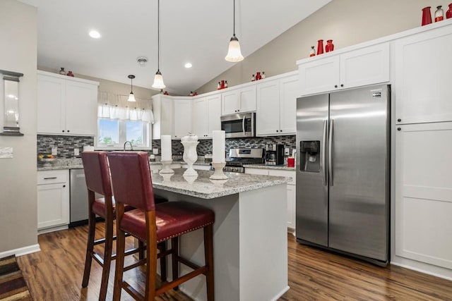722 Hilltop Dr, Taylors Falls, MN 55084 - kitchen with stainless steel appliances, decorative backsplash, white cabinets, lofted ceiling, and recessed lighting