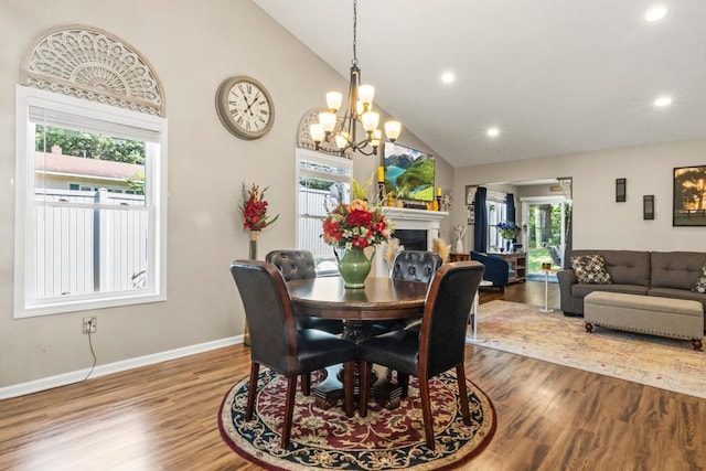 722 Hilltop Dr, Taylors Falls, MN 55084 - dining space with wood finished floors, a fireplace, high vaulted ceiling, a chandelier, and recessed lighting
