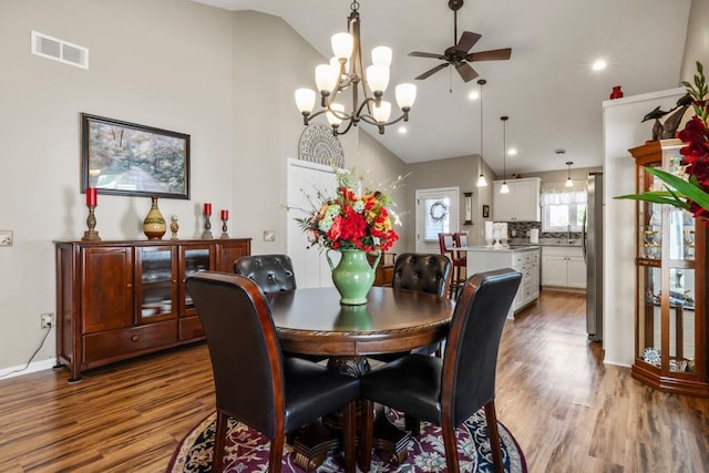 722 Hilltop Dr, Taylors Falls, MN 55084 - dining area with wood finished floors, a chandelier, a ceiling fan, and high vaulted ceiling