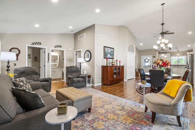 722 Hilltop Dr, Taylors Falls, MN 55084 - living room featuring wood finished floors, ceiling fan, recessed lighting, high vaulted ceiling, and a chandelier