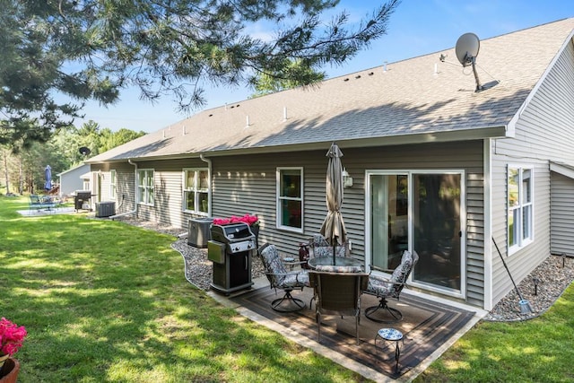 722 Hilltop Dr, Taylors Falls, MN 55084 - back of house featuring a patio area, a lawn, and roof with shingles