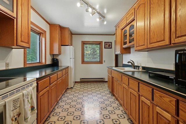 19316 Miller Rd, Dell Grove Twp, MN 55072 - kitchen with baseboard heating, brown cabinets, light flooring, dark countertops, and ornamental molding
