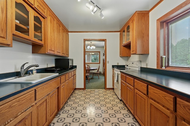 19316 Miller Rd, Dell Grove Twp, MN 55072 - kitchen featuring white electric range oven, dark countertops, glass insert cabinets, brown cabinetry, and light flooring
