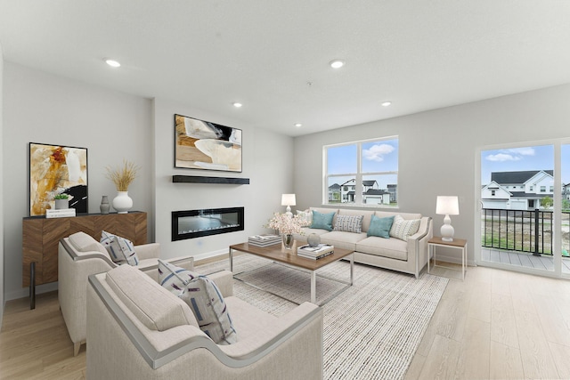 2726 Kepler Ave NE, Saint Michael, MN 55376 - living area with light wood-type flooring, healthy amount of natural light, a glass covered fireplace, and recessed lighting