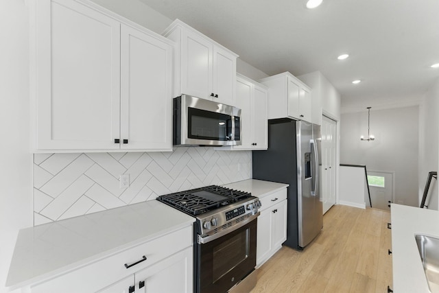 2726 Kepler Ave NE, Saint Michael, MN 55376 - kitchen featuring stainless steel appliances, light countertops, recessed lighting, tasteful backsplash, and white cabinetry