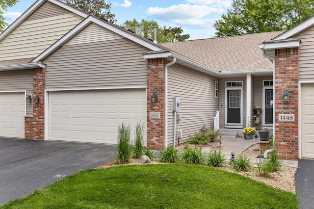 1437 131st Dr NE, Blaine, MN 55449 - view of front of property featuring a garage, driveway, brick siding, and a shingled roof