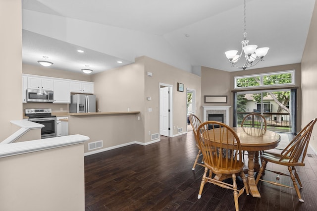 1437 131st Dr NE, Blaine, MN 55449 - dining space featuring lofted ceiling, dark wood finished floors, a chandelier, a tile fireplace, and recessed lighting