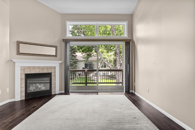 1437 131st Dr NE, Blaine, MN 55449 - unfurnished living room featuring dark wood finished floors and a tile fireplace