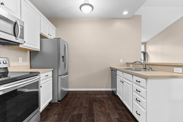 1437 131st Dr NE, Blaine, MN 55449 - kitchen featuring appliances with stainless steel finishes, a peninsula, dark wood-type flooring, white cabinetry, and light countertops