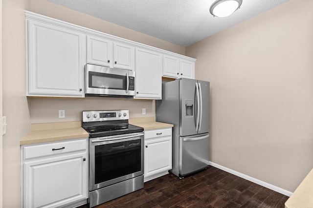 1437 131st Dr NE, Blaine, MN 55449 - kitchen featuring stainless steel appliances, dark wood-style floors, white cabinets, light countertops, and a textured ceiling