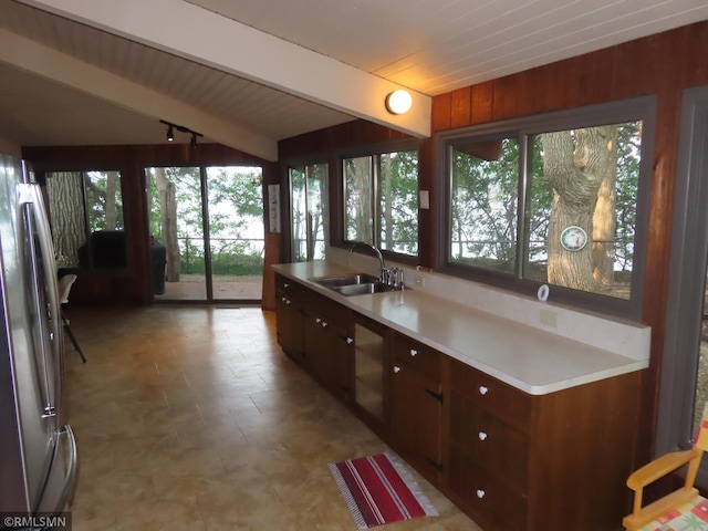 9429 Jeske Ave NW, Corinna Twp, MN 55302 - kitchen featuring freestanding refrigerator, plenty of natural light, light countertops, beamed ceiling, and light flooring