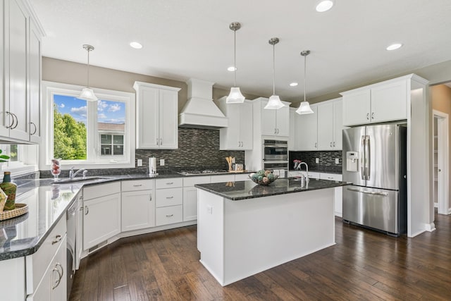 9721 Emerson Ct, Eden Prairie, MN 55347 - kitchen featuring stainless steel appliances, custom range hood, tasteful backsplash, white cabinetry, and a kitchen island with sink