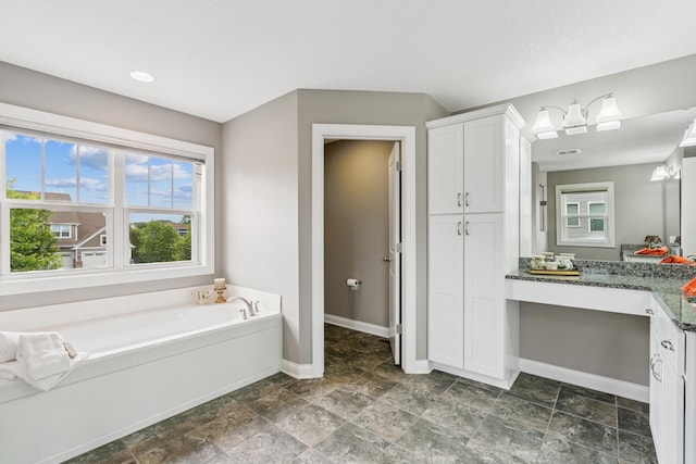 9721 Emerson Ct, Eden Prairie, MN 55347 - full bath with vanity, a bath, stone finish floors, and a closet