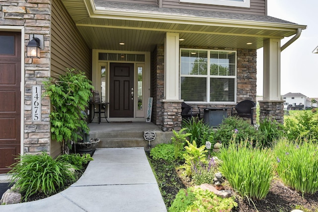 14675 77th St NE, Otsego, MN 55330 - doorway to property with a porch, stone siding, and roof with shingles
