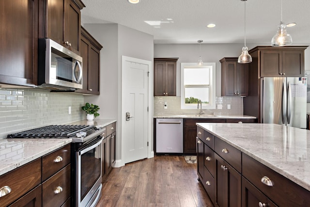 14675 77th St NE, Otsego, MN 55330 - kitchen with stainless steel appliances, dark wood-style floors, dark brown cabinets, pendant lighting, and recessed lighting