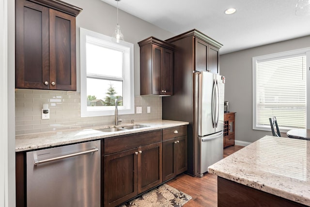14675 77th St NE, Otsego, MN 55330 - kitchen featuring appliances with stainless steel finishes, dark brown cabinetry, wood finished floors, tasteful backsplash, and recessed lighting