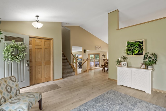 5278 River Wood Dr, Savage, MN 55378 - foyer entrance featuring wood finished floors, stairs, and high vaulted ceiling