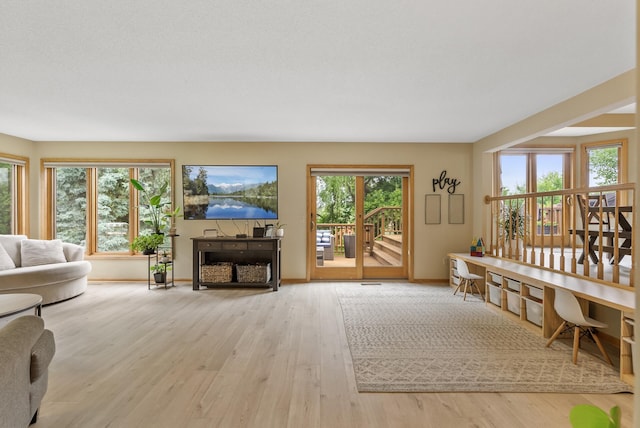 5278 River Wood Dr, Savage, MN 55378 - living area with healthy amount of natural light, wood finished floors, and a fireplace