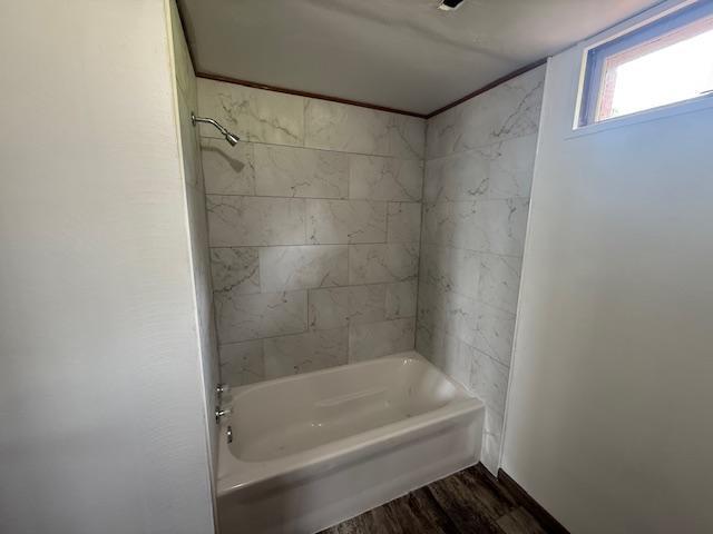 103 Circle Dr, Jackson, MN 56143 - bathroom with wood finished floors and shower / bathtub combination