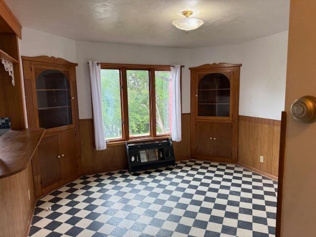 103 Circle Dr, Jackson, MN 56143 - unfurnished dining area featuring wainscoting, wooden walls, and light flooring