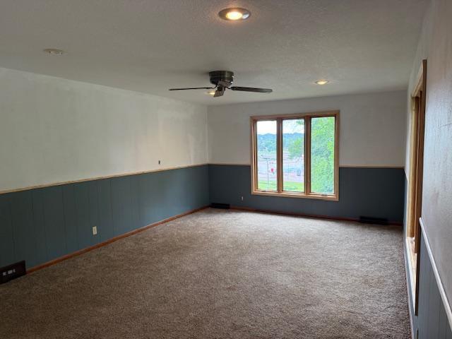 103 Circle Dr, Jackson, MN 56143 - carpeted empty room with ceiling fan and wainscoting