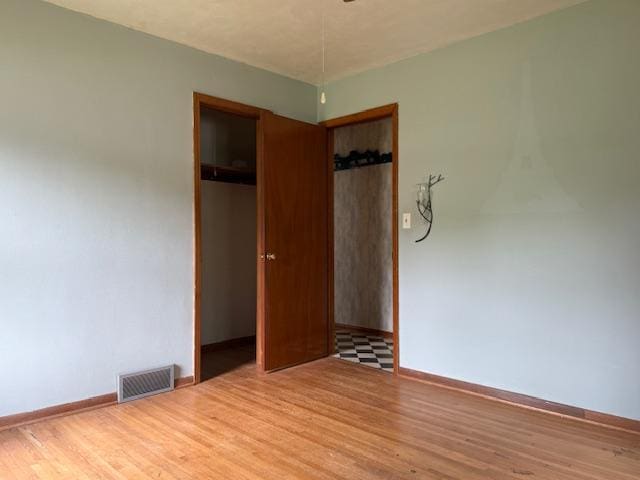 103 Circle Dr, Jackson, MN 56143 - unfurnished bedroom with wood finished floors and a closet