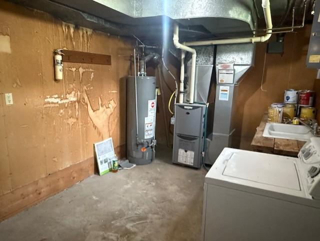 103 Circle Dr, Jackson, MN 56143 - unfinished below grade area with water heater and washer / clothes dryer