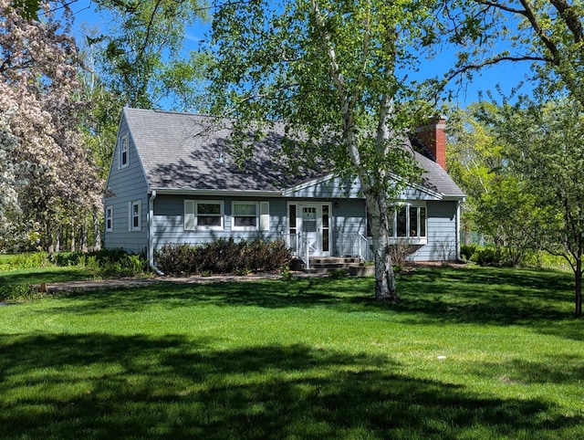 1138 Wintergreen Ln NE, Bemidji, MN 56601 - view of front facade featuring a front yard, a chimney, and roof with shingles