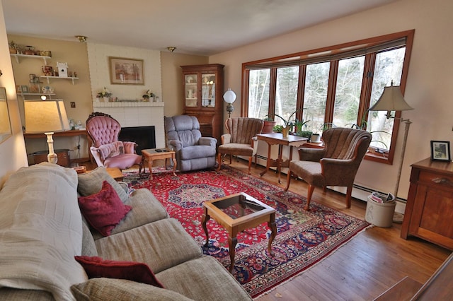 1138 Wintergreen Ln NE, Bemidji, MN 56601 - living area with wood finished floors and a brick fireplace