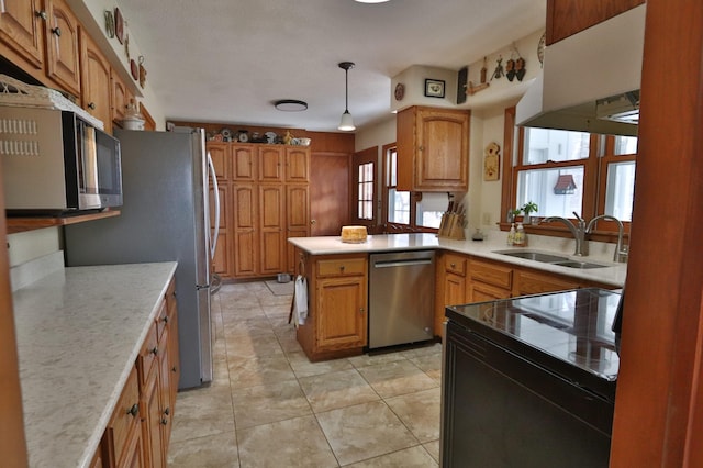 1138 Wintergreen Ln NE, Bemidji, MN 56601 - kitchen with stainless steel appliances, plenty of natural light, a peninsula, and hanging light fixtures