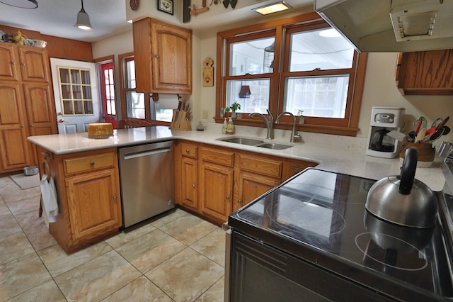 1138 Wintergreen Ln NE, Bemidji, MN 56601 - kitchen with stainless steel dishwasher, range hood, plenty of natural light, and brown cabinets